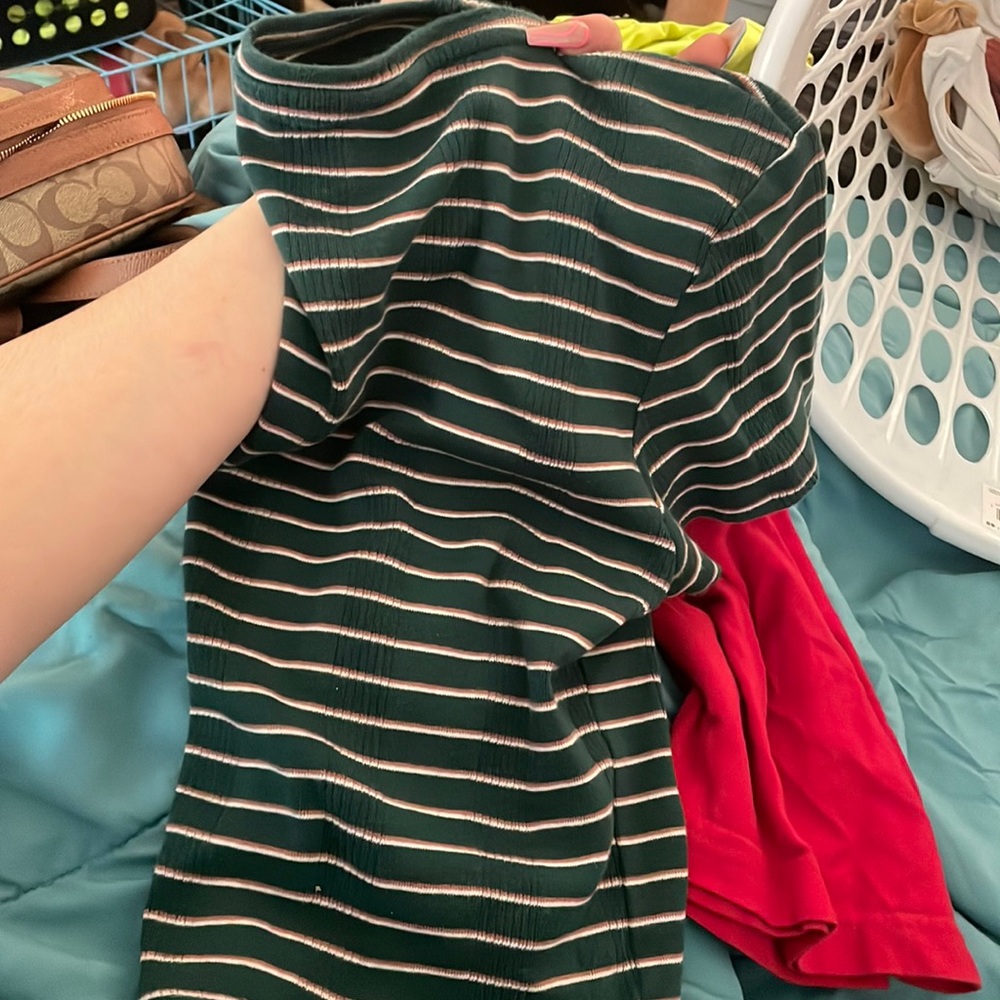 A green shirt with orange and white stripes
